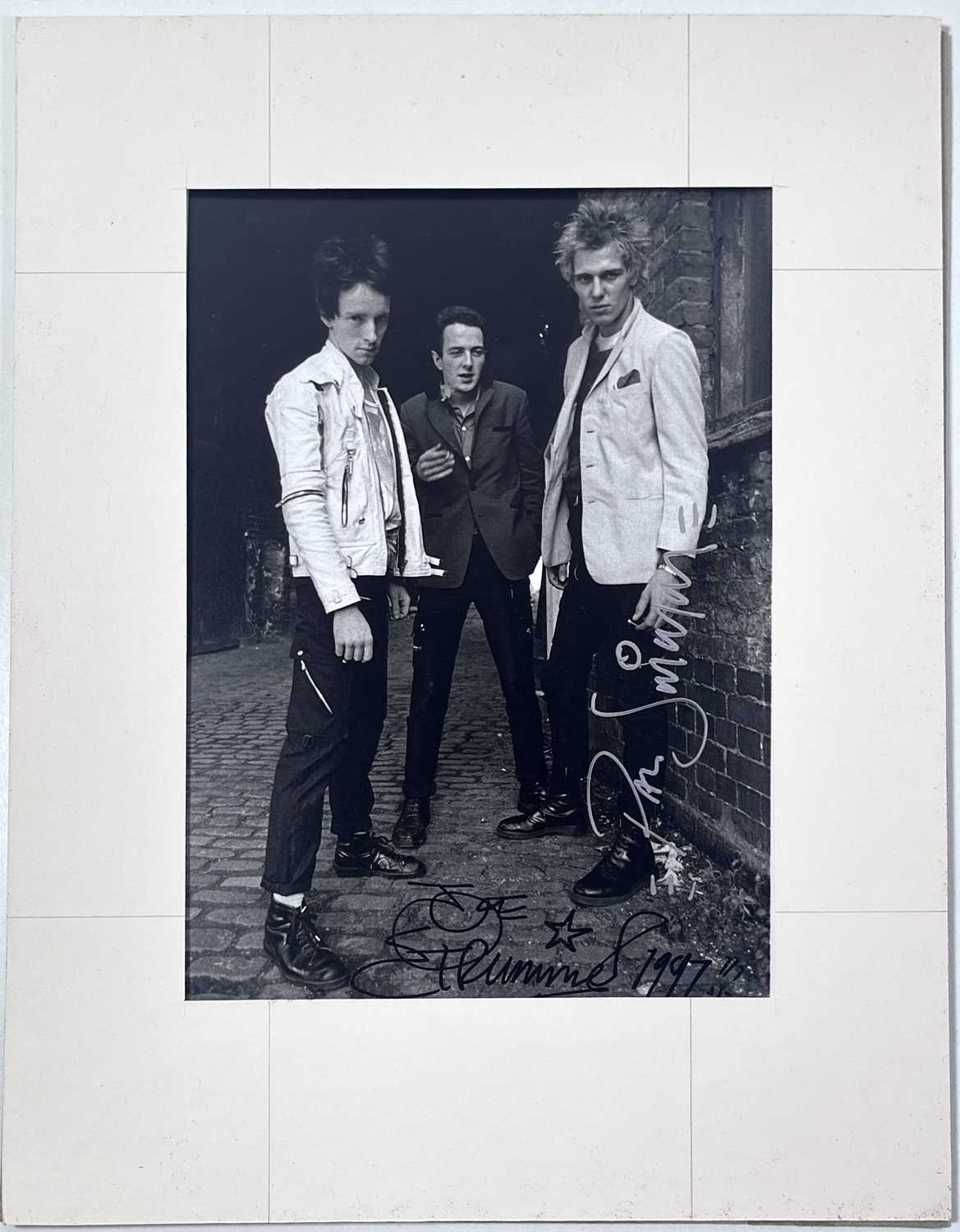 Lot 45 - THE CLASH - PAUL SIMONON AND JOE STRUMMER SIGNED PHOTOGRAPH.