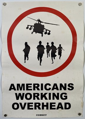 Lot 365 - BANKSY - ORIGINAL 'AMERICANS WORKING OVERHEAD' STICKER.